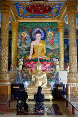 Pitu Khosa Rangsay buddhist pagoda.  Man and woman praying the Buddha. Can Tho. Vietnam.  25.02.2017