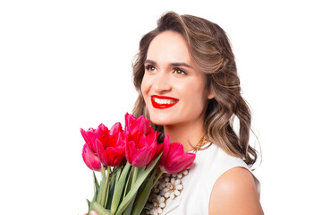 Close up portrait of cheerful woman smiling with bouquet of tulips.