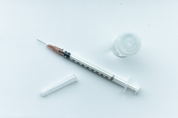 Vial with coronavirus vaccine and syringe for children or adults on white background against polyamilitis, covid, smallpox, measles diseases