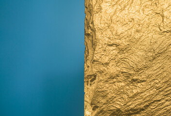 Gold texture. Rough structure mineral. Rock texture. Gold Ore. Gold rocks. Stone blue background.
