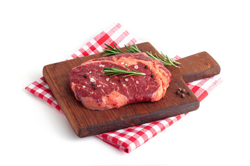 Raw rib eye steak of beef with rosemary isolated on white background