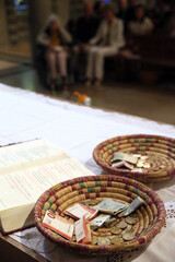 Our Lady Full of Grace of the Plateau d'Assy. Collection during a Catholic Mass. Basket with Euros. 22.03.2018