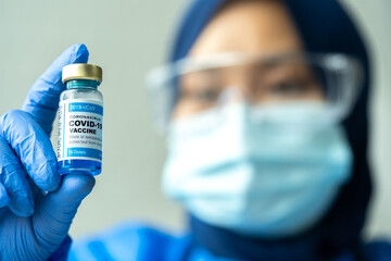 Medical concept ampoules or vials with Covid-19 vaccine on a laboratory bench