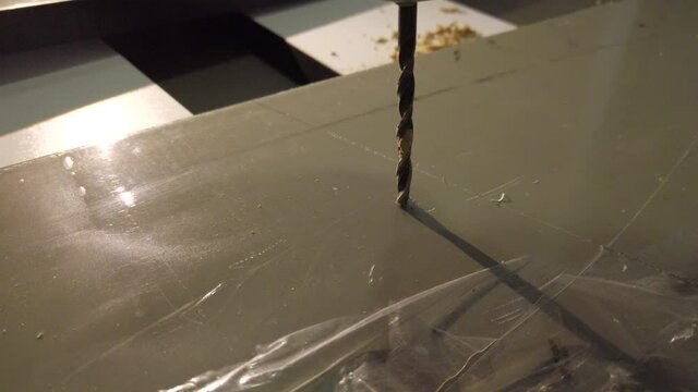 Hand drill making hole in an mdf board. DIY home project