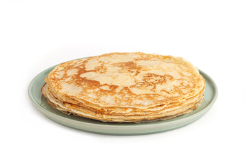 Pancake on the green plate. Many pancakes are stacked