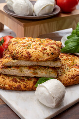 Tasty italian vegetarian food, fresh baked flat foccachia bread with white mozzarella cheese and herbs