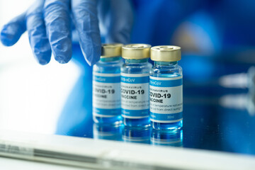 Medical concept ampoules or vials with Covid-19 vaccine on a laboratory bench