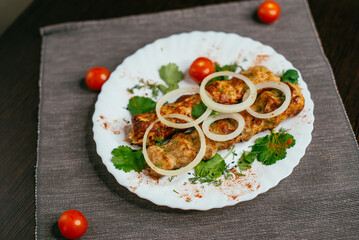 lula kebab on a plate with onions