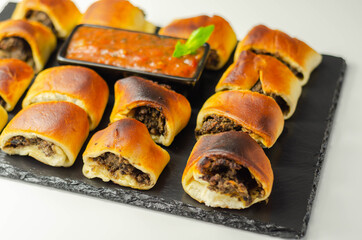 Patty's pies stuffed with minced meat, mushrooms and onion, served with sauce