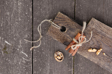 Pieces of walnut and cinnamon sticks on a wooden board. High quality photo