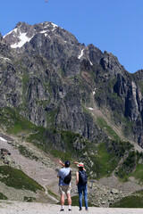 Fototapeta premium French Alps. Mont Blanc Massif. Walkers on a path above the Chamonix Valley, France. 18.07.2016