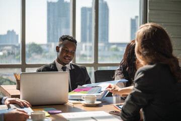 Diversity Business and Work palce concept. African businessman and businesswoman team colleague woking with docuement in office with laptop computer.