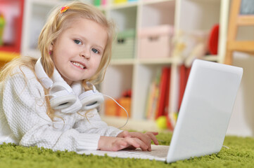 girl with  headphones using laptop