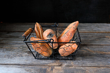 Trendy ugly organic produce  - сarrots (a few pieces)  on the table in a basket . Horizontal...