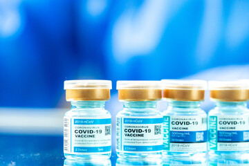 Medical concept ampoules or vials with Covid-19 vaccine on a laboratory bench.