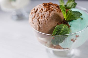 Chocolate, mint and vanilla ice-cream set in sundae bowl, refreshing creamy dessert for summertime. Food background