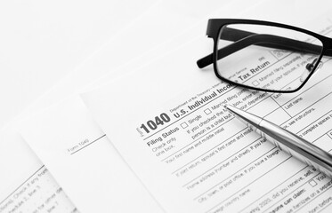 United States American IRS Internal Revenue Service income tax filing form 1040 for revenue reporting preparation with financial papers