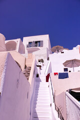 Santorini, Greece : Low Angle View Of Steps In Between white colored Houses In famous touristic island of Greece