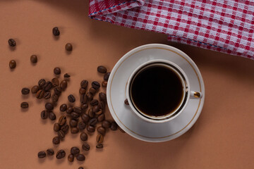 Fresh aromatic coffee in a mug with coffee beans. Morning coffee. Coffee break. 