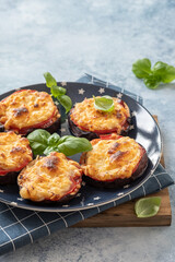 Baked eggplant with parmesan cheese, tomatoes and basil