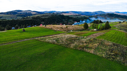 Drone shot of summer mountains landscape. Aerial view of panoramic overview of nature travel green tree forest. 