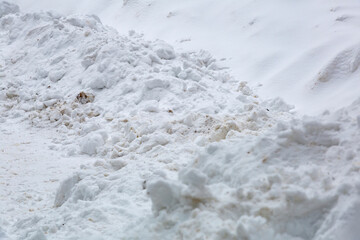 Textured surface of dirty snowdrift on winter day
