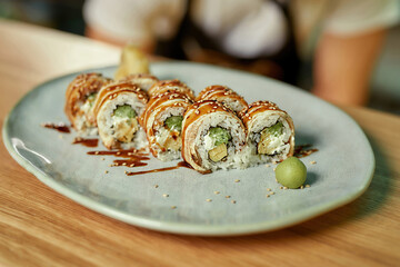 Close up shot of tasty sushi rolls ready for eating served on plate in a restaurant