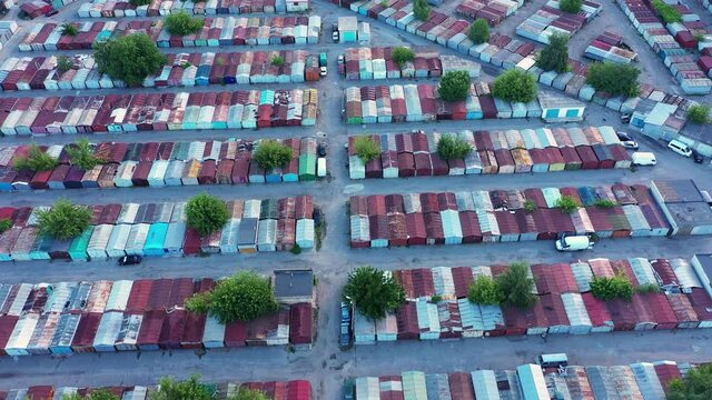 A large warehouse of metal containers on a summer day - aerial shot. Flying a drone over a plethora of multi-colored metal storage containers