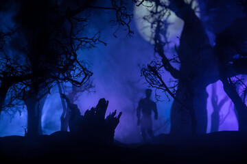 bloodthirsty zombies attacking. hungry zombies in the woods. Silhouettes of scary zombies walking in the forest at night