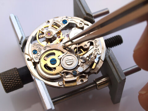 watchmaker repairing classic mechanical watch movement