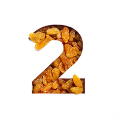 Number two of raisins and paper cut in shape of second numeral isolated on white. Natural typeface of dried berries