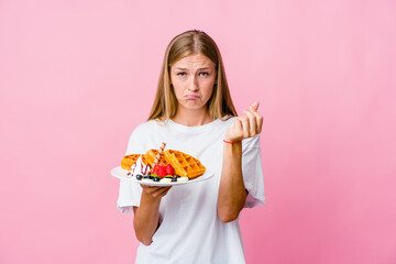 Young russian woman eating a waffle isolated showing that she has no money.