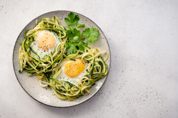 fried egg in zucchini noodle nest, healthy breakfast