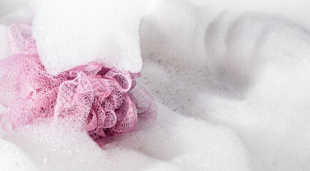 Purple washcloth and white foam all around. Abstract background