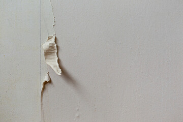Abstract texture of a rough wall with torn wallpaper. Repair Texture