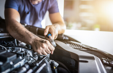 Auto mechanic working and repair on car engine in mechanics garage. Car service.