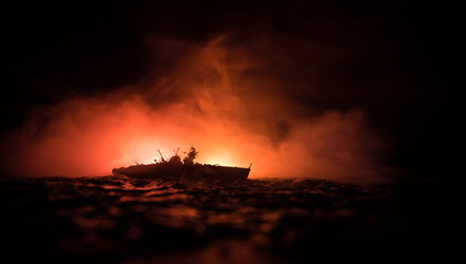 Silhouettes of a crowd standing at blurred military war ship on foggy background. Selective focus....