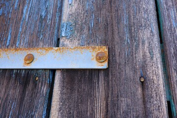 old wooden door with worn paint and rusty metal