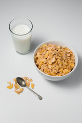 Healthy breakfast with cornflakes and milk on isolated background