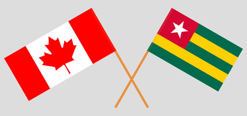 Crossed flags of Canada and Togo. Official colors. Correct proportion