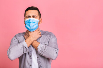 Protection against contagious disease, coronavirus, covid-19. Man wearing hygienic mask to prevent infection, airborne respiratory illness such as flu, 2019-nCoV. Isolated over pink background