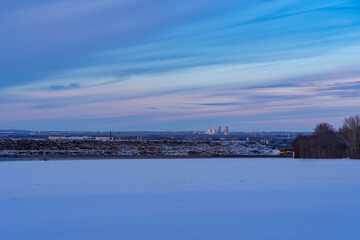 winter evening in a field outside the city