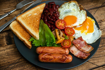 Rustical breakfast eggs, sausages, vegetables. Selective focus