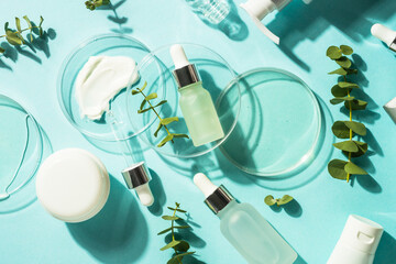Cosmetic laboratory concept . Glass petri dish with cosmetic products, serum bottles, cream, tonic...
