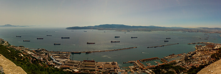 Aerial view of the Strait of Gibraltar taken on the rock of Gibraltar. Image shows hazy horizon with silhouettes of the Rif mountains of North Africa as well as a number of ships crossing the passage © Grandbrothers