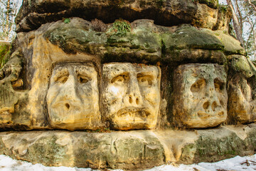 Harfenice Natural Formations are large sandstone blocks of sculptures carved into sandstones.Monumental giant heads and other artworks in pine forest near Zelizy village,Czech Republic.Cliff carvings.
