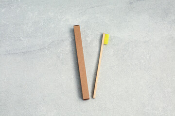 Ecological Bamboo toothbrushe with yellow nylon bristles and brown paper box