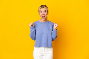 Young Russian woman isolated on yellow background celebrating a victory in winner position