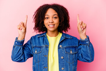 Young african american mixed race woman isolated indicates with both fore fingers up showing a...