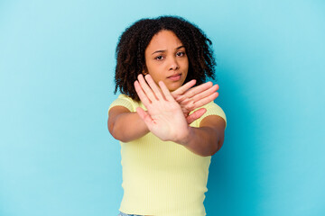 Young african american mixed race woman isolated doing a denial gesture